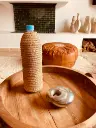 Cache bouteille en feuille de palmier tressée